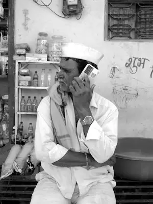 Trader in traditional clothes on a phone call