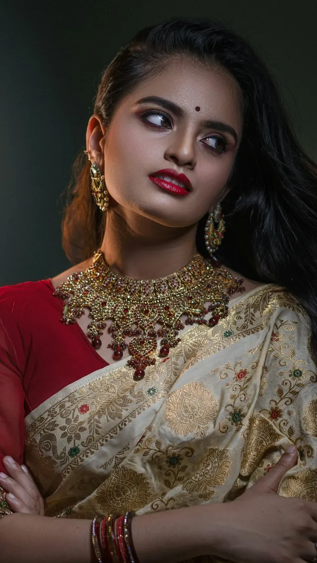 Model in a red and gold sari during a shoot